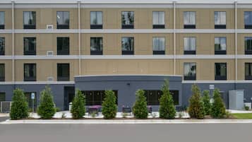A multi-story building with a flat facade, evenly spaced windows, and a central entrance.