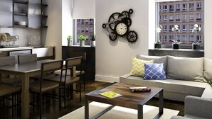 A modern living room with a sofa, coffee table, and dining area.