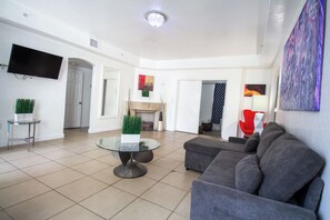 Apartment, 4 Bedrooms | Living area | 32-inch flat-screen TV with cable channels, TV