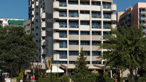 A multi-story hotel with balconies, a sign reading 'Bellevue,' and a beach in the foreground. - Hotel Sentido Bellevue Beach Sunny Beach (Nessebar)