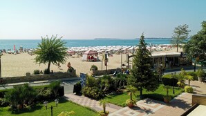 A beachside hotel with a view of the sea, outdoor seating, and a covered area. - Hotel Sentido Bellevue Beach Sunny Beach (Nessebar)