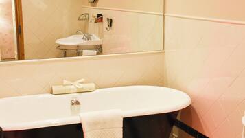 A bathroom with a bathtub, toilet, and sink.