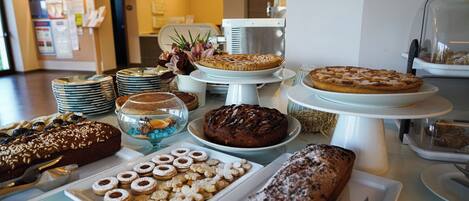A buffet with various desserts and pastries.