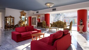 A spacious lobby with red sofas, a grand mirror, and ornate furniture. - Zante Imperial Beach Hotel (Zakynthos)