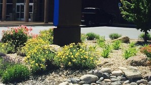 A sign for a Hyatt Place hotel with a modern building in the background. - Hyatt Place Reno Tahoe Airport (Reno)