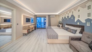 A modern hotel room with a large bed, a sofa, a desk, and a TV. - Aria Resort & Spa Hotel (Alanya)