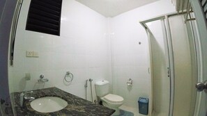 A bathroom with a sink, toilet, and shower.