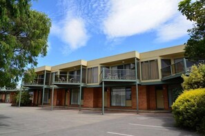 A multi-story building with a flat roof, large windows, and a parking lot in front. - Comfort Inn and Suites Lakes Entrance (Lakes Entrance)