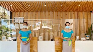 A reception area with wooden paneling and a glass partition. - Jonys Beach Resort (Boracay Island)