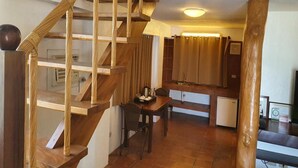A wooden staircase leading to a dining area with a table and chairs, a small refrigerator, and a window with curtains. - Jonys Beach Resort (Boracay Island)