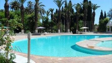 Piscine extérieure, parasols de plage, chaises longues
