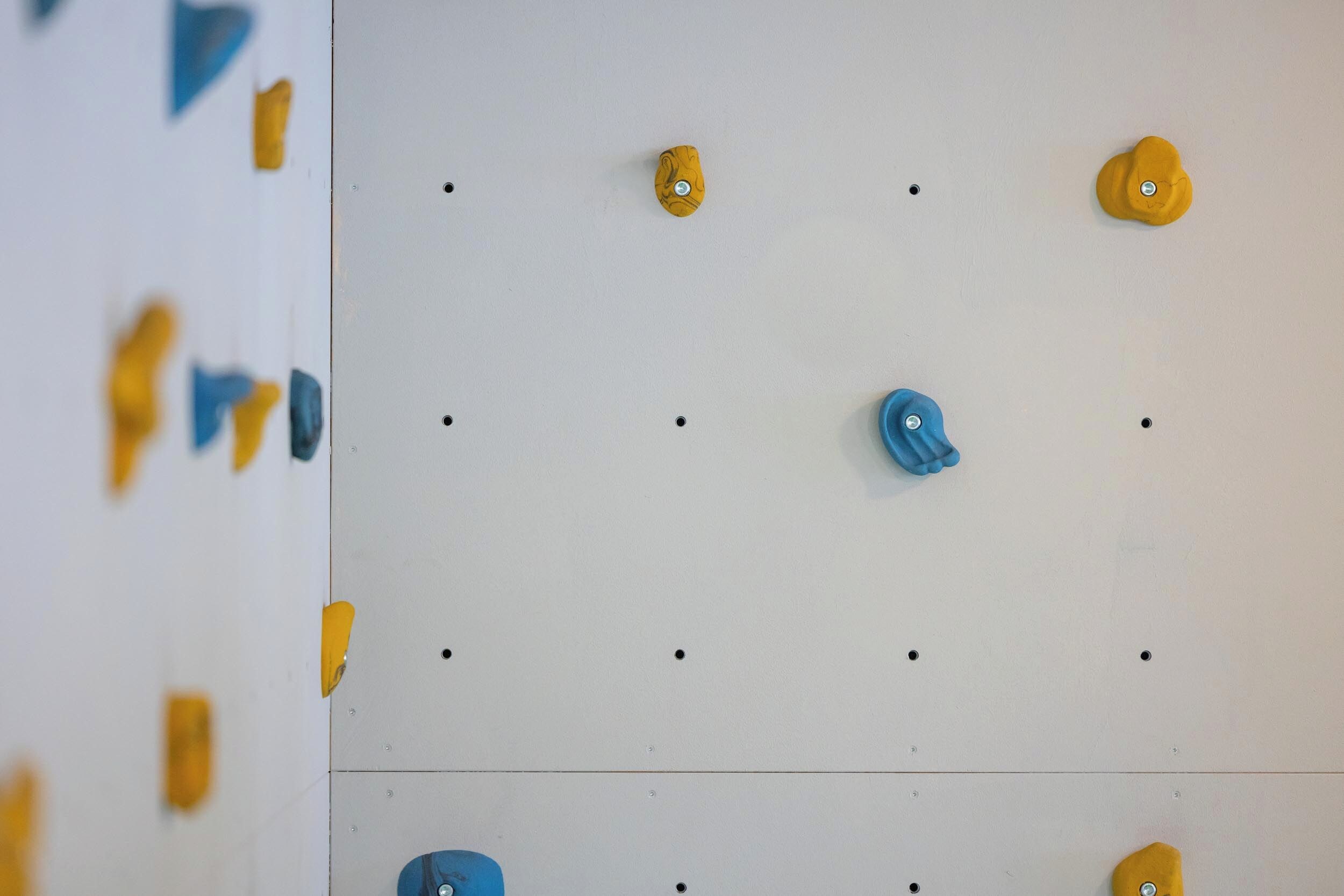Una pared con presas de escalada dispuestas en un patrón de cuadrícula.