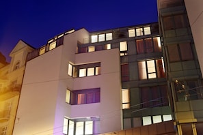 A multi-story building with balconies and windows, featuring a modern architectural style. - Ambassador (Lucerne)
