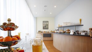 A breakfast buffet with various food items and a beverage dispenser. - Ambassador (Lucerne)