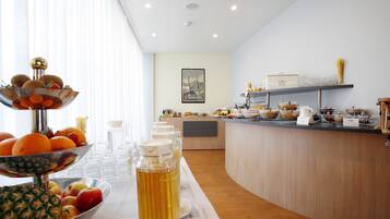 A breakfast buffet with various food items and a beverage dispenser.
