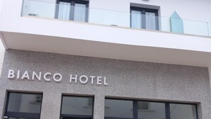 A modern hotel facade with the name "BIANCO HOTEL" prominently displayed. - Bianco Hotel (Leros)