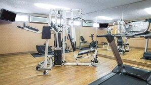 A gym with various exercise machines, a treadmill, and a mirrored wall. - Quality Inn & Suites Casper Near Event Center (Casper)