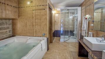 A bathroom with a bathtub, shower, and sink.