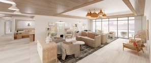 A spacious living area with a large window, a wooden ceiling, and a modern sofa set.