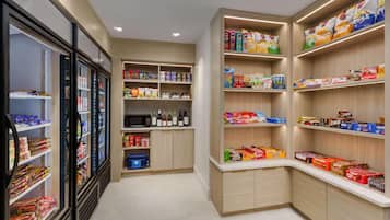A well-organized pantry with shelves stocked with snacks, beverages, and condiments.