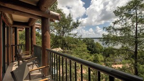A wooden balcony with a view of a lake and trees. - Copper Creek Villas and Cabins at Disneys Wilderness Lodge (Lake Buena Vista)