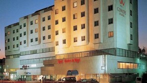 A multi-story hotel with a sign reading "HOTEL" and "CONDES DE URGENC". - Condes de Urgel (Lleida)