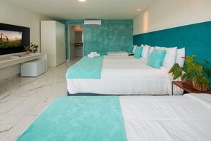 A hotel room with two beds, a TV, a small fridge, and a bathroom visible through an open door. - Pousada Aroma do Mar (Búzios)