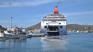 A ferry docked at a harbor with a mountainous backdrop. - Castelli (Patmos)