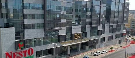 A modern building with a large sign for NESTO Hypermarket.