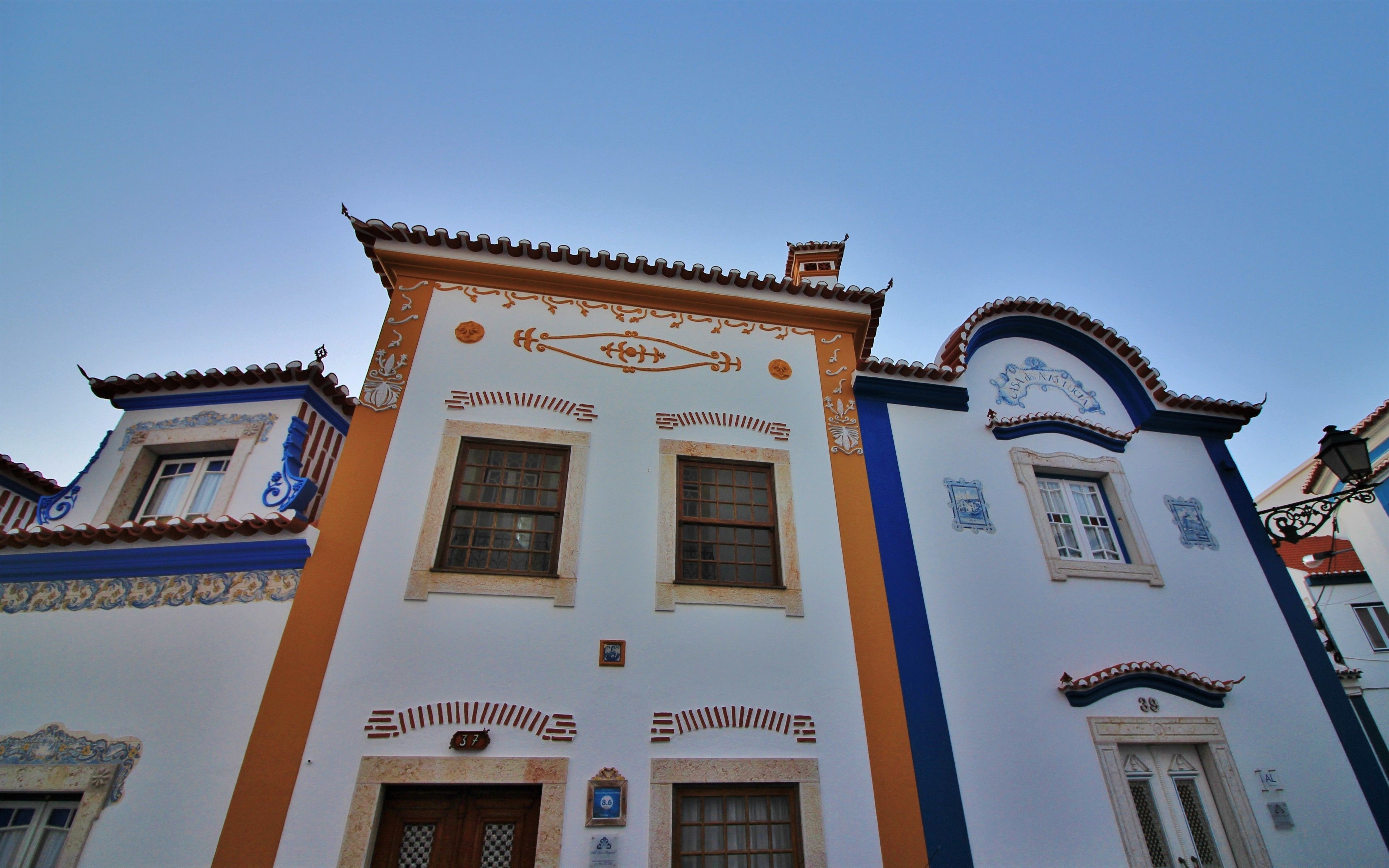 A building with a traditional architectural style, featuring ornate decorations and multiple windows.