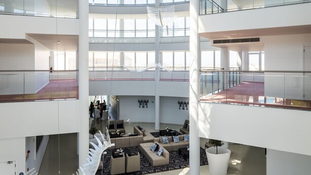 A spacious, multi-level atrium with modern furnishings and a central spiral staircase. - Mh Peniche, Peniche, Portugal (Peniche)
