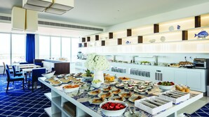 A buffet setup with various food items and a decorative vase. - Mh Peniche, Peniche, Portugal (Peniche)