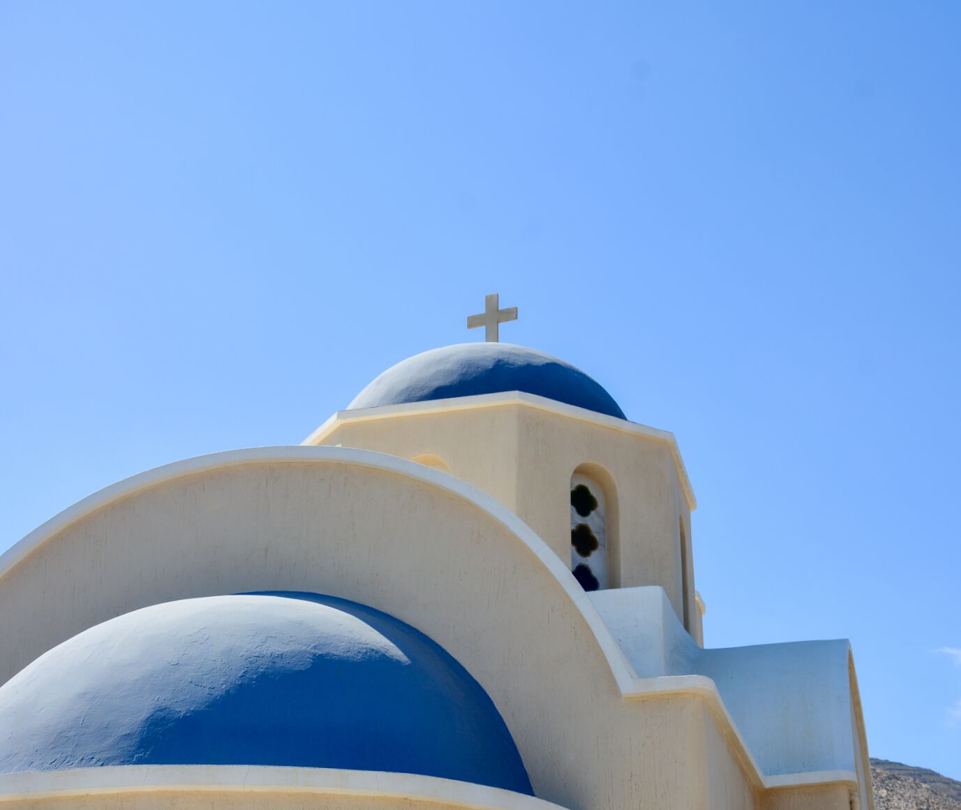 A building with a dome and a cross on top.