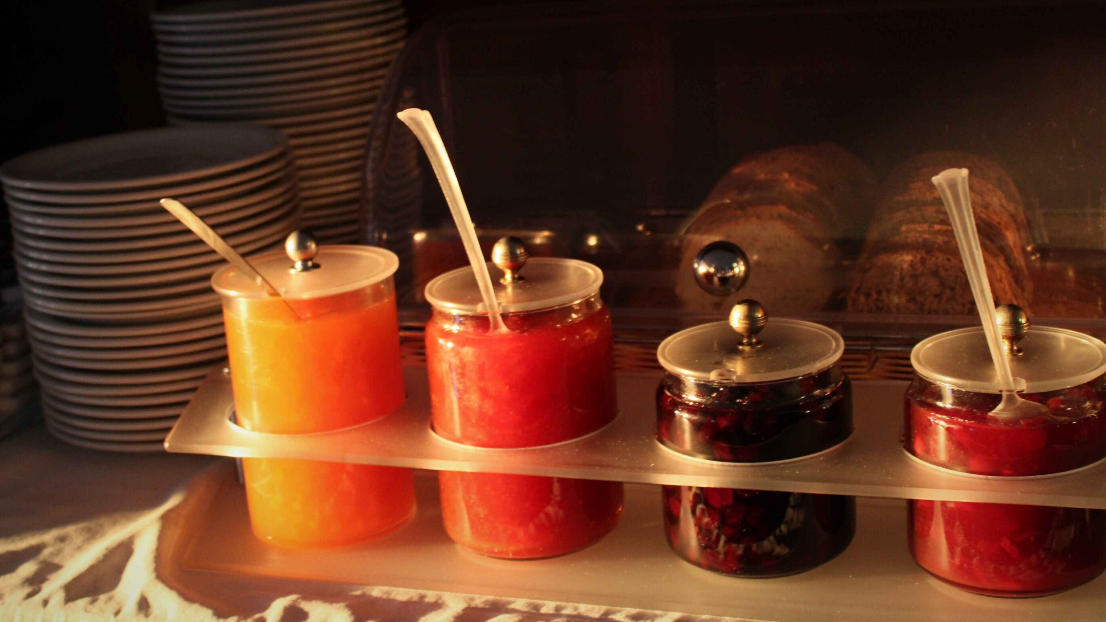 A display of food items with lids and straws, possibly in a buffet setting.