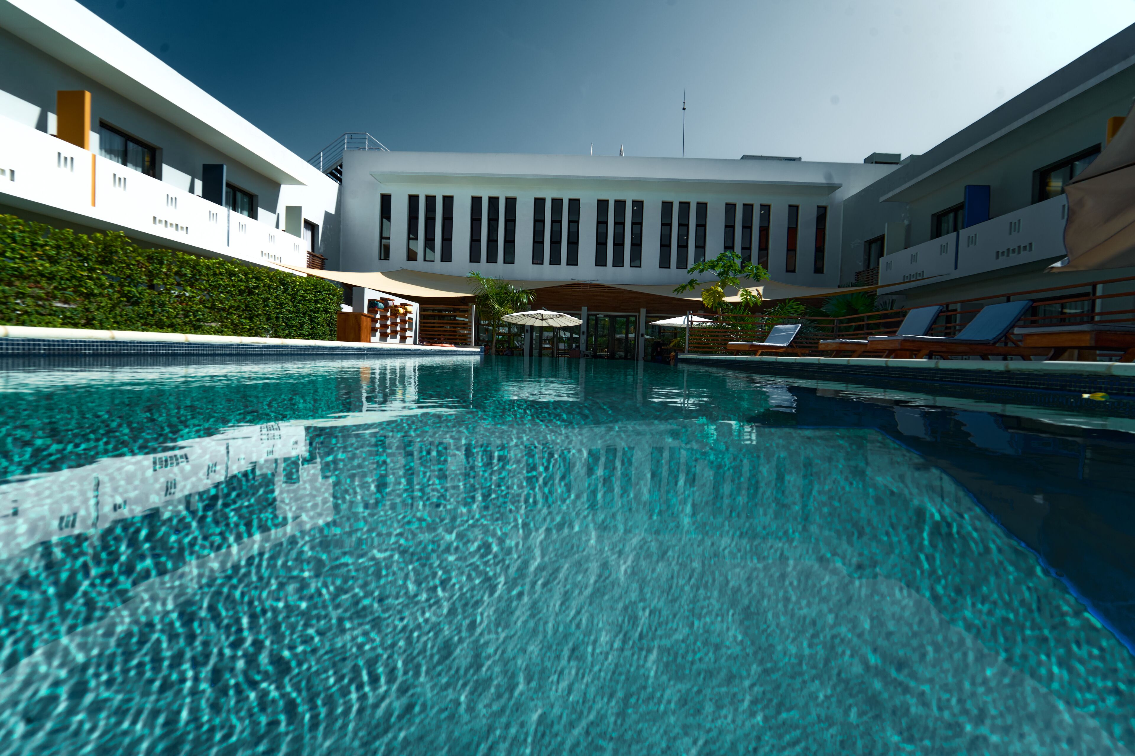 outdoor pool, open 7:00 am to 7:00 pm, pool umbrellas, pool loungers