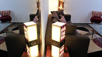 A modern living room with a sofa, two armchairs, a coffee table, and a floor lamp.