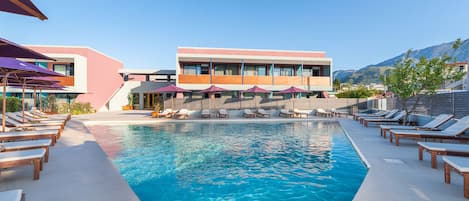 Outdoor pool, open 10:00 AM to 8:00 PM, pool umbrellas, pool loungers