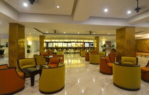 A spacious lobby with a bar area, multiple seating arrangements, and a polished floor. - Canto del Sol Puerto Vallarta All Inclusive (Puerto Vallarta)