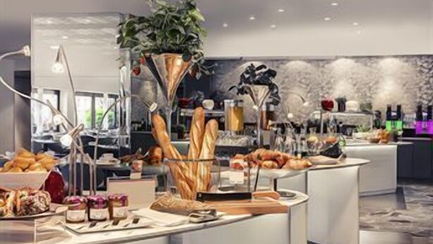A buffet setup with various food items and a decorative plant. - Hôtel Mercure Marseille Centre Vieux-Port (MARSEILLE)