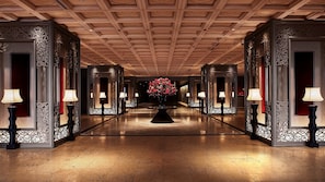 A hotel corridor with ornate wooden paneling, a central floral arrangement, and wall-mounted lamps. - Tokyo Prince (Tokyo)
