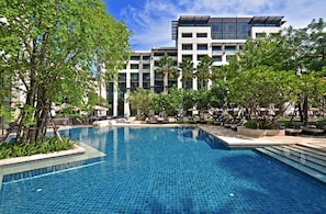 A swimming pool with a modern building in the background.