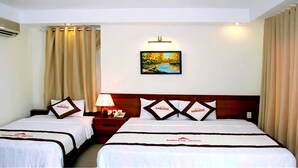 A hotel room with two beds, a nightstand with a lamp, a painting on the wall, and curtains. - Paradise Hotel (Da Nang)