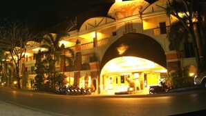 A hotel with a large arched entrance, multiple balconies, and a well-lit facade. - Koh Chang Resort Spa (Ko Chang)