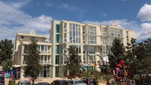 A multi-story building with large windows and a flat roof.