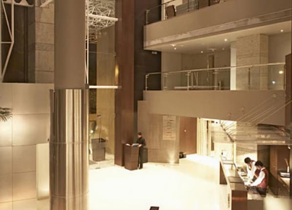 Experience the grandeur of our lobby, featuring a spacious central area, reception desk, and comfortable seating.