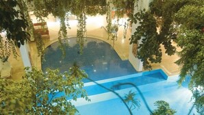 An indoor swimming pool with a blue floor and the word "Rubis" visible. - Rubi Hotel (Alanya)