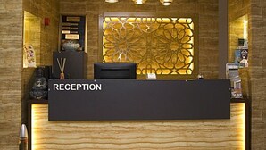A reception desk with a sign reading "RECEPTION" in a hotel lobby. - Istcity Hotel (Istanbul)