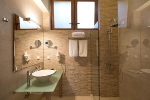 A modern bathroom with a glass-enclosed shower, a large mirror, a sink with a glass countertop, and a towel rack. - Thalatta Seaside Hotel (Mantoudi-Limni-Agia Anna)