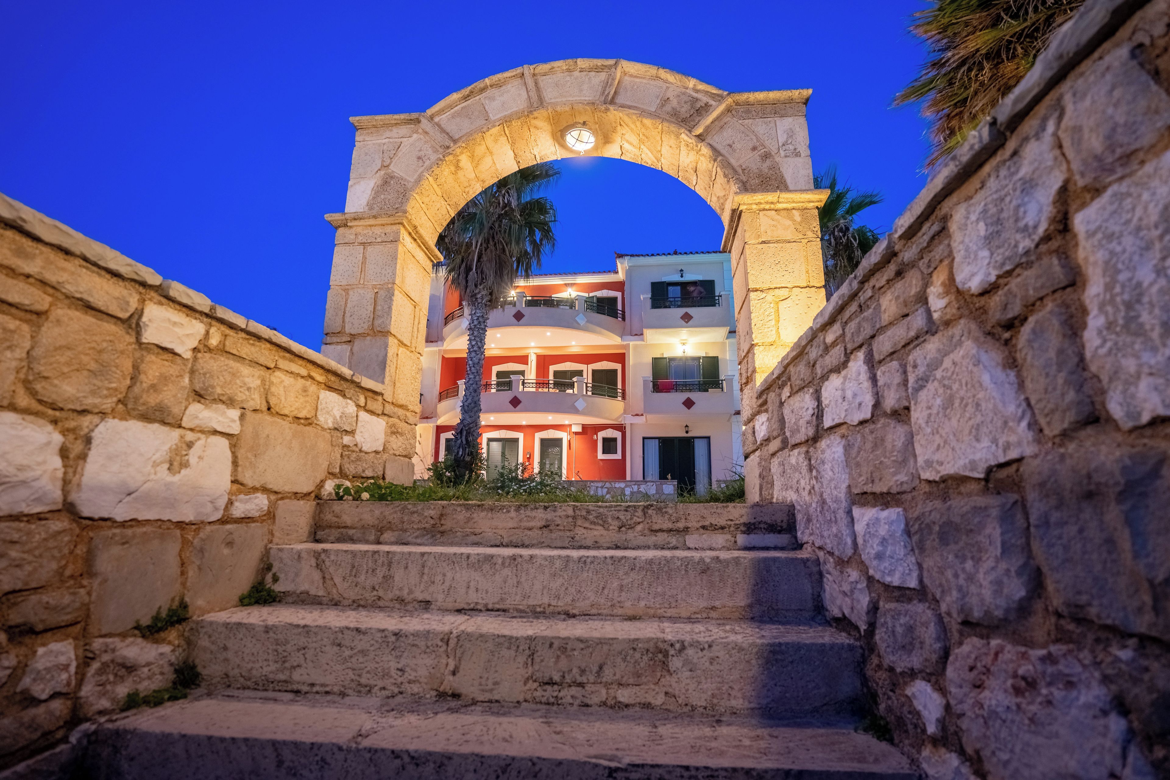 A stone staircase leading to a building with a stone archway.