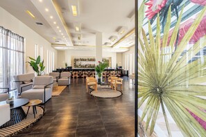 A spacious lobby with a bar area, comfortable seating, and a large decorative plant. - Akti Coast Club Hotel (Kos)